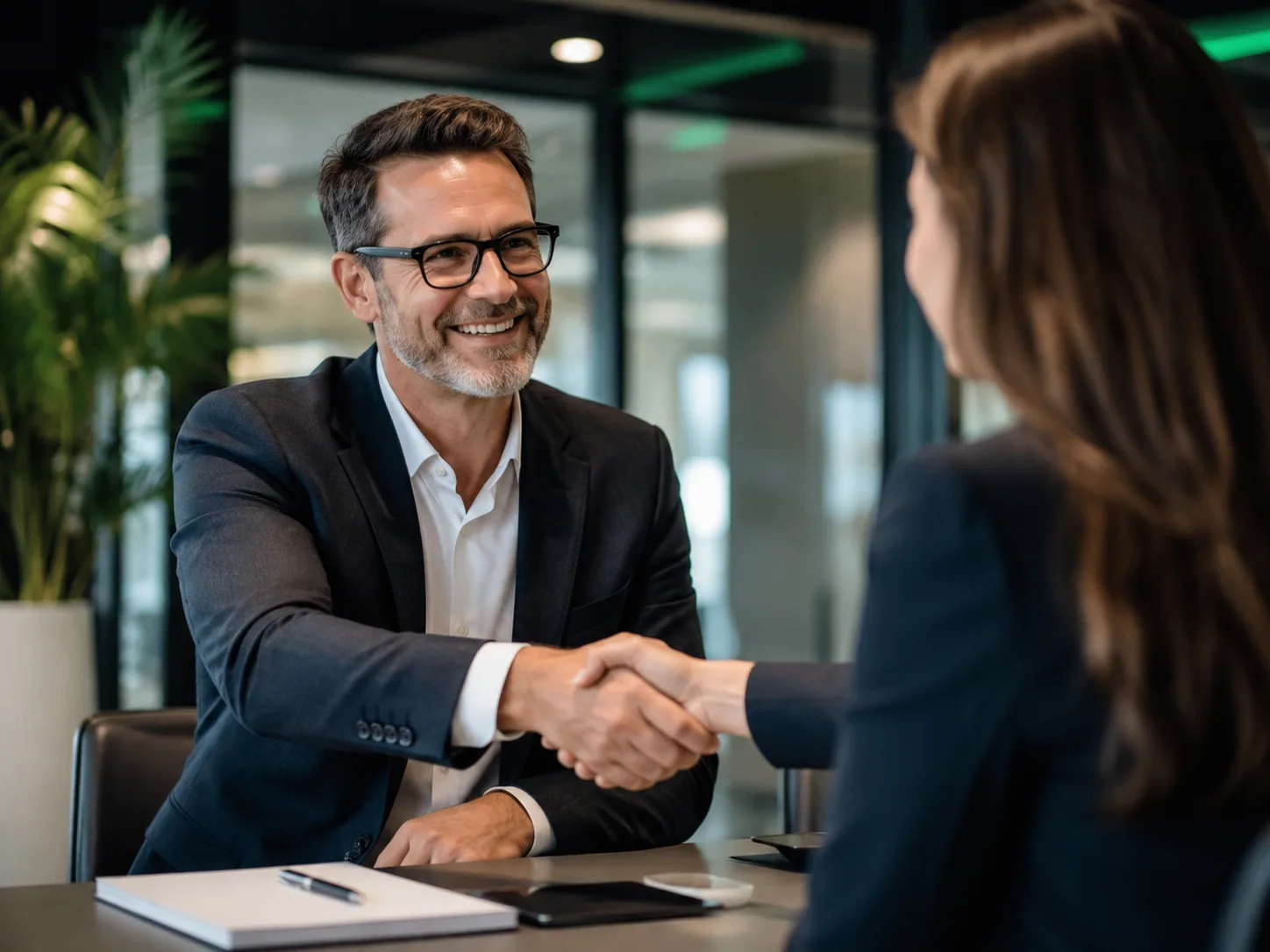 Professional handshake in a modern office representing trust and support